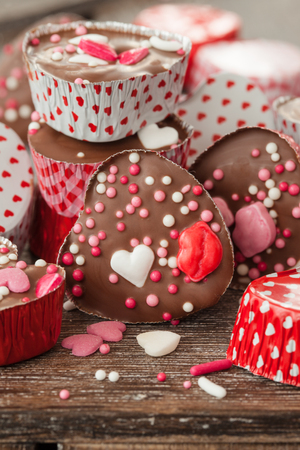 Homemade heart chocolates with colorful sugar sprinklesの写真素材
