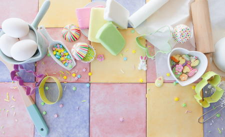 Colorful ingredients for baking and decorating easter cookies