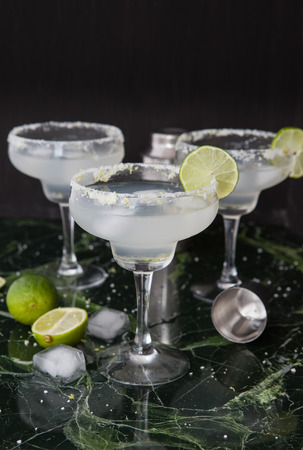 Ice cold Margarita Cocktails in stem glasses with salted rimの写真素材