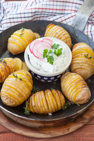 Rustic hasselback potatoes with fresh thyme and sea saltの写真素材