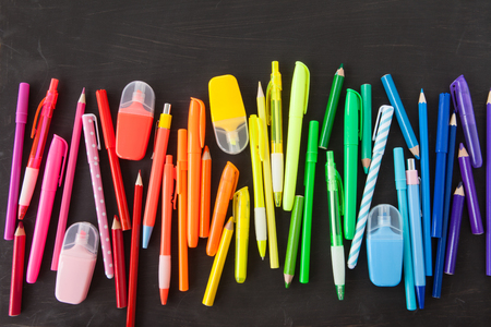 Variety of colorful pens in a rainbow on black backgroundの写真素材