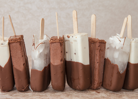 Chocolate covered ice cream with vanilla and coconutの写真素材
