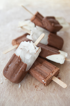 Chocolate covered ice cream with vanilla and coconutの写真素材