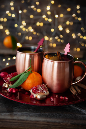 Two mugs of mulled wine with cinnamon and pomegranateの写真素材