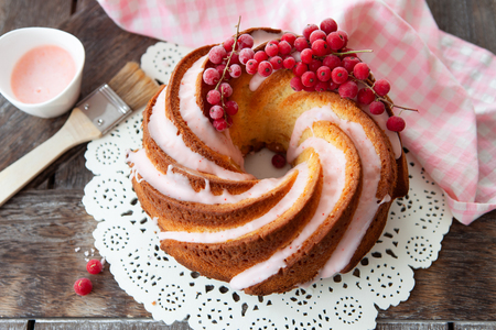Yummy bundt cake with red currants and pink frostingの写真素材