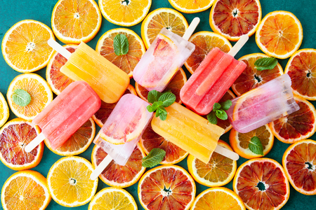Frozen ice pops with fresh citrus fruits and mint leavesの写真素材