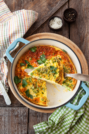 Delicious baked fritatta with peas, potatoes and fresh parsleyの写真素材
