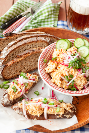 Traditional bavarian cheese dish with fresh sliced rye breadの写真素材
