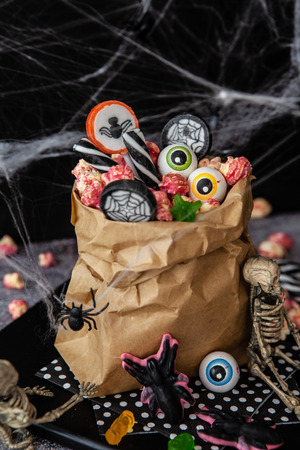 Paper bag full of colorful candy for Halloweenの写真素材