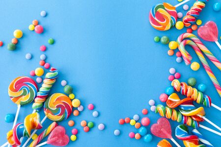 Colorful sweets and lollipops on a blue backgroundの写真素材