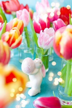 Fresh colorful tulips and a little happy easter bunnyの写真素材