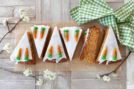 Homemade carrot cake with frosting and candy carrots