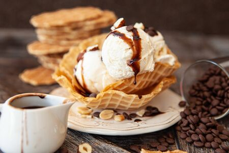 Scoops of vanilla ice cream in a waffle cupの写真素材
