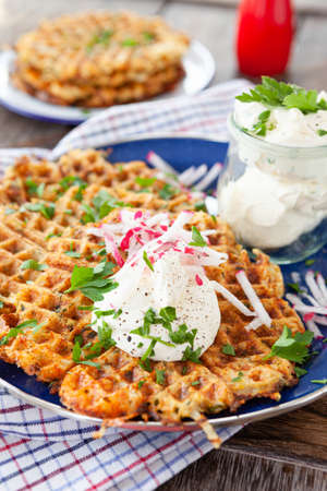 Savory potato waffles / pancakes with sour creamの写真素材