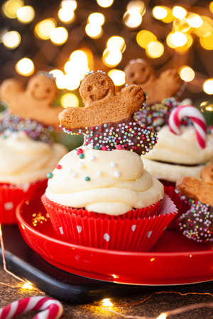 Yummy Cupcakes with butter cream frosting and gingerbread cookies for Christmasの写真素材