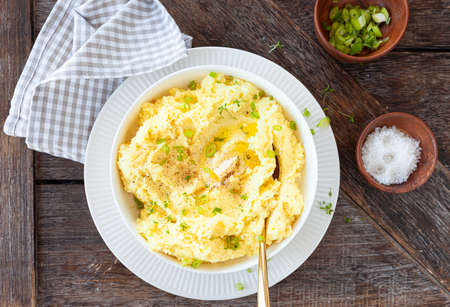 Homemade mashed potatoes with melting butter and fresh herbsの写真素材