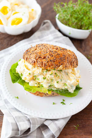 Bread roll with homemade egg salad and lettuceの写真素材