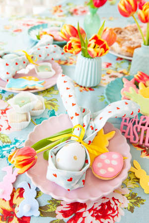 Colorful table setting with sweets for Easter