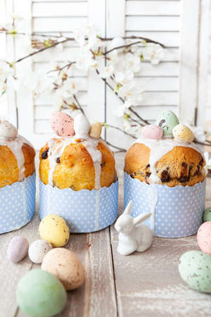 Little panettone cakes with sugar frosting and easter eggs