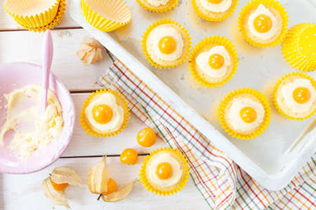 Little cupcakes looking like fried eggs, sunny side up, for Easterの写真素材
