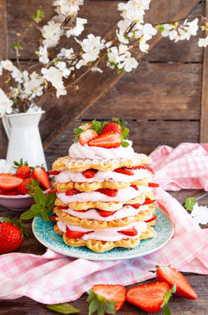 Waffles stacked with whipped cream and fresh strawberriesの写真素材