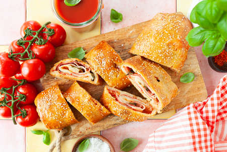 Italian stromboli, delicious pizza roll filled with sausage and hamの写真素材
