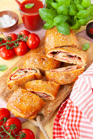Italian stromboli, delicious pizza roll filled with sausage and hamの写真素材