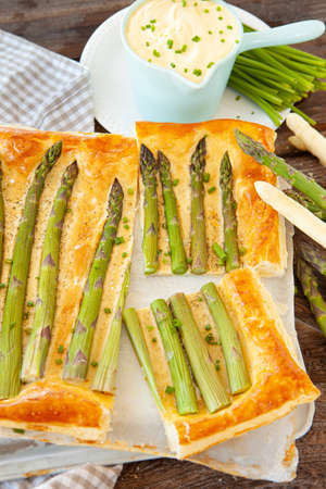 Savory puff pastry quiche with green asparagusの写真素材
