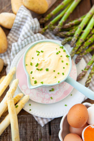 Hollandaise sauce with fresh green and white asparagusの写真素材