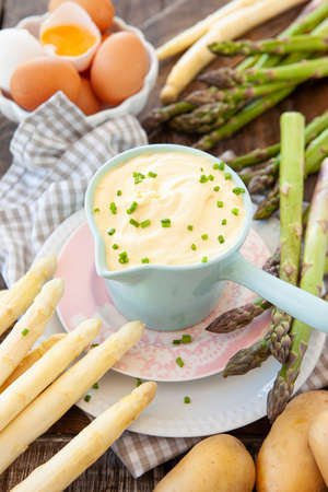 Hollandaise sauce with fresh green and white asparagusの写真素材