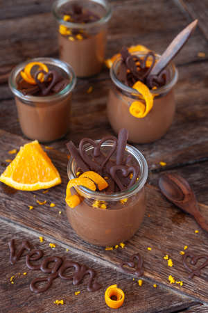 Vegan chocolate mousse with orange zest in little jarsの写真素材