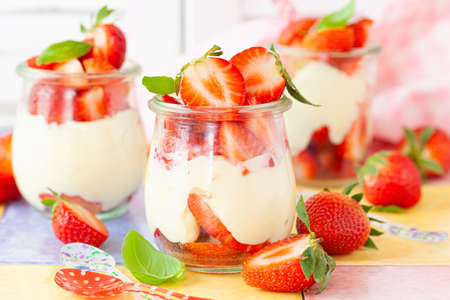 Cream dessert with fresh stawberries and basilの写真素材