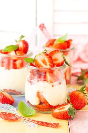 Cream dessert with fresh stawberries and basilの写真素材