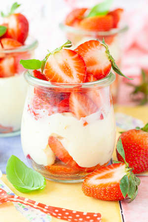 Cream dessert with fresh stawberries and basilの写真素材