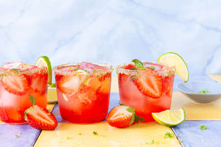 Ice cold cocktail with fresh strawberries and limeの写真素材