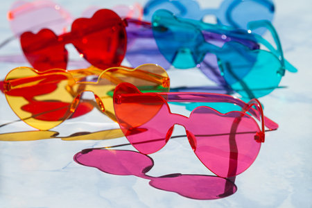 Colorful sunglasses in heart shaped on a blue backgroundの写真素材