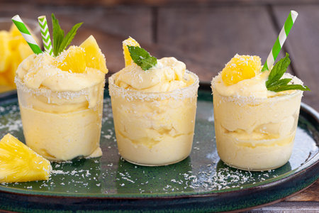 Delicious pineapple soft serve with coconut flakes and mint leavesの写真素材