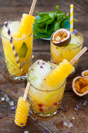 Ice cold cocktail with fresh passion fruit and mint leavesの写真素材