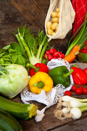 Colorful variety of fresh vegetables on rustic wooden backgroundの写真素材