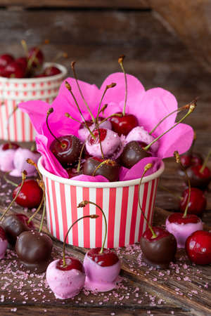 Chocolate covered cherries with pink sugar sprinklesの写真素材