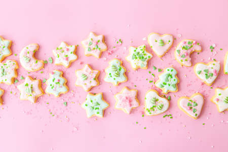 Colorful Christmas cookies with sugar sprinkles on a pink backgroundの写真素材