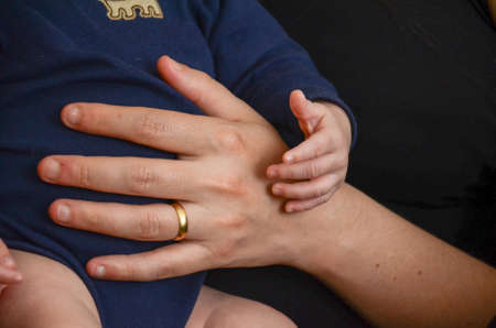A mother and her child's hands are holding each other, Montevideo, Uruguay.の写真素材