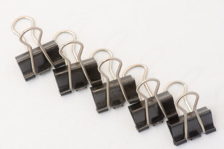 Closeup of several paper clips in different positions and arranged randomly.の写真素材