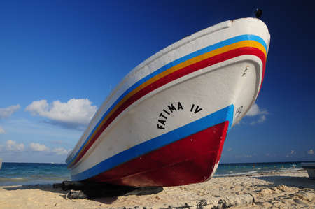 Fishing boat at Playa del Carmen beach during the sunset. Playa del Carmen, Quintana Roo, Mexico.Some clouds in the sky can be seen at the background of the picture.の写真素材