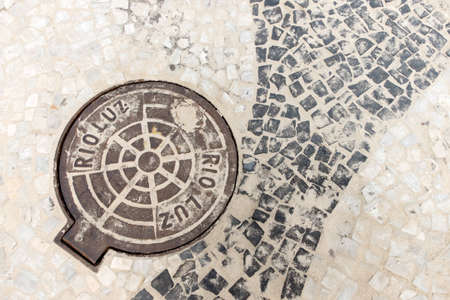 Detail of the sewer cover and sidewalk on Copacabana beach in Rio de Janeiro, Brazilの写真素材