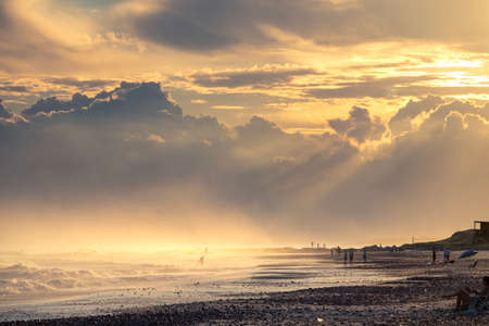 "Gorgeous sunset with some golden myst at Bella Vista beach. Some surfers entering the ocean it the background.Maldonado, UruguayGorgeous sunset with some golden myst at Bella Vista beach. Some surfers entering the ocean it the background.Maldonado, Uruguay"の写真素材
