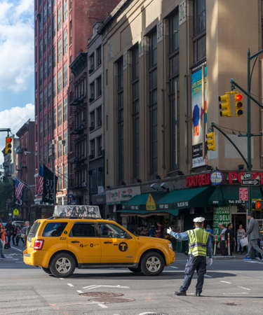 NEW YORK CITY, NY/USA - OCTOBER 16TH, 2014: A traffic police man is redirecting the traffic at W 42nd St Ave during an intervention in Times Square area, October 16th, 2014, New York City, NY, USA.のeditorial素材