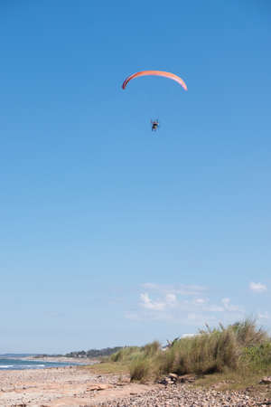 Parasailing over Las Flores Beach, on a very hot day during the summer at Maldonado, Uruguay.