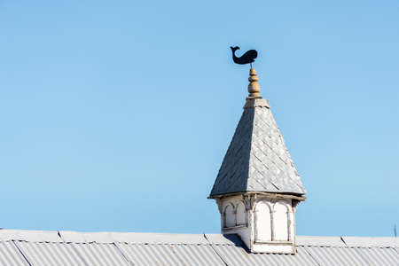 "Wind vane over an old building at Ushuaia, Tierra del Fuego, Argentina. "の写真素材
