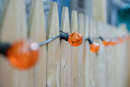 Orange light decoration over a fence in a backyard.Harlem, Upper Side Manhattan, New York City, New York, USAの写真素材
